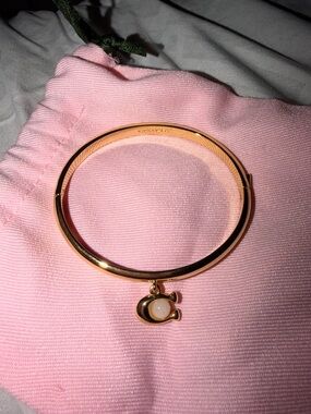 Coach Gold-Tone Bangle Bracelet with Pink Charm